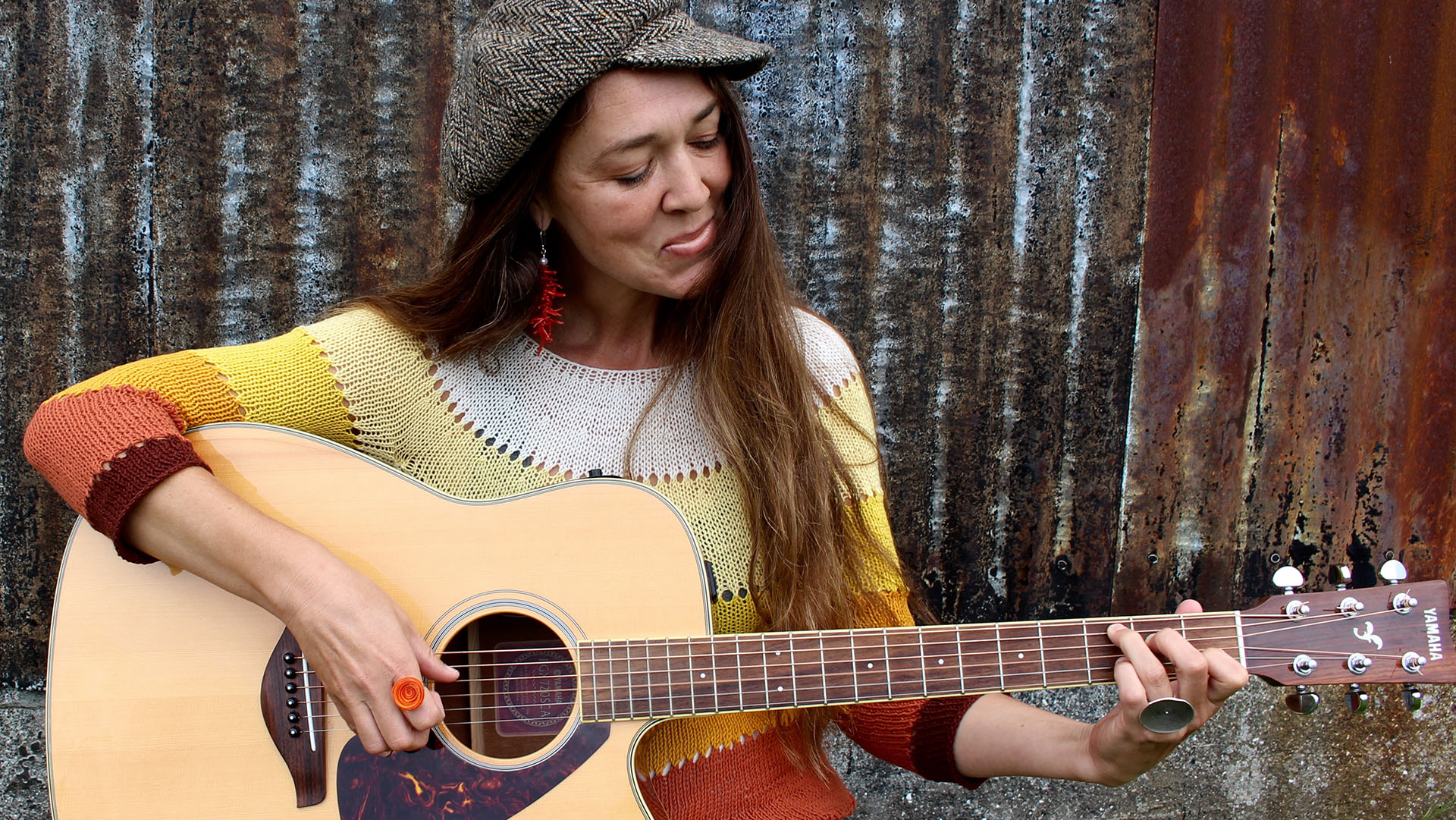 kristina jacobsen playing an acoustic guitar